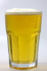 a frosty glass of beer with white background