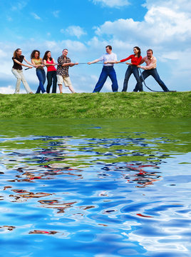 Group Of People Pulling The Rope