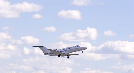 Fototapeta na wymiar White Jet in Clouds