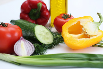 Multi-coloured vegetables for salad on a white background