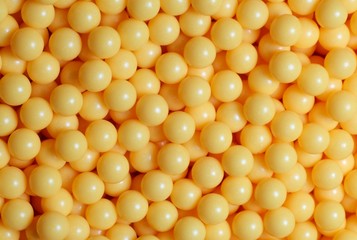 A pile of yellow round balls.