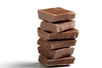 Stack of brown chocolate on white background