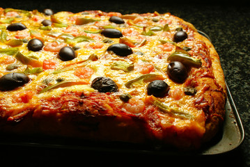 Pizza with prawns on baking tray