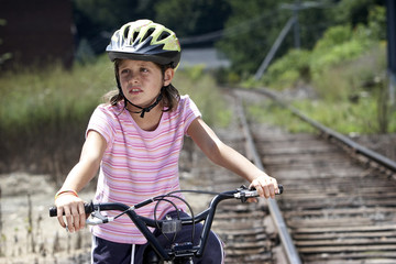 Naklejka premium Girl on bike, looking away