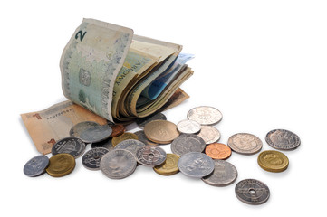 Banknotes and coins spread randomly on a table.