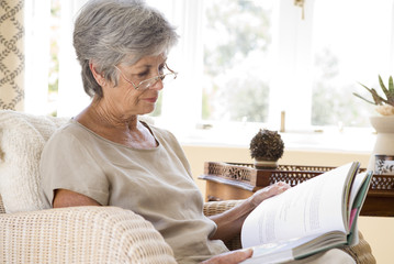 Senior woamn at home reading book