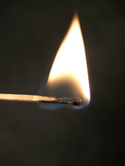 Burning match on a dark background. Fire.