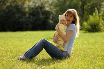 Fototapeta premium mother and child on green grass