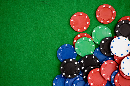 Poker chips on green background. Room for text.