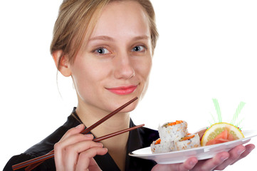 Pretty girl eating sushi with chopsticks