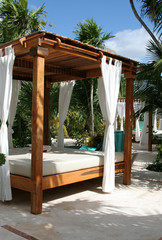 A poolside beach bed at a tropical resort..
