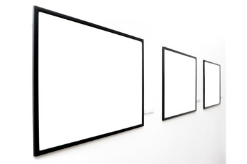 Three  empty frames on white wall