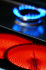 Ceramic stove of electric cooker and blue flames of gas stove