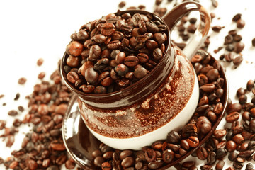Cup of coffee beans on white