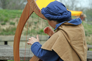 a celtic harp player during a medieval fair in Italy
