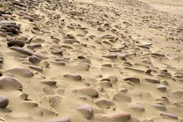 Pebbles on a sandy beach