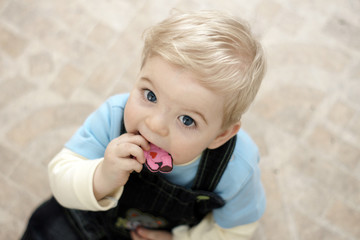 blond baby with toy