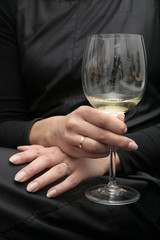 women hand with glass of wine