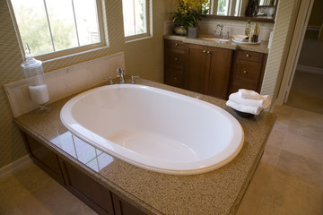 Spacious bathroom with a modern tub and tile floor.