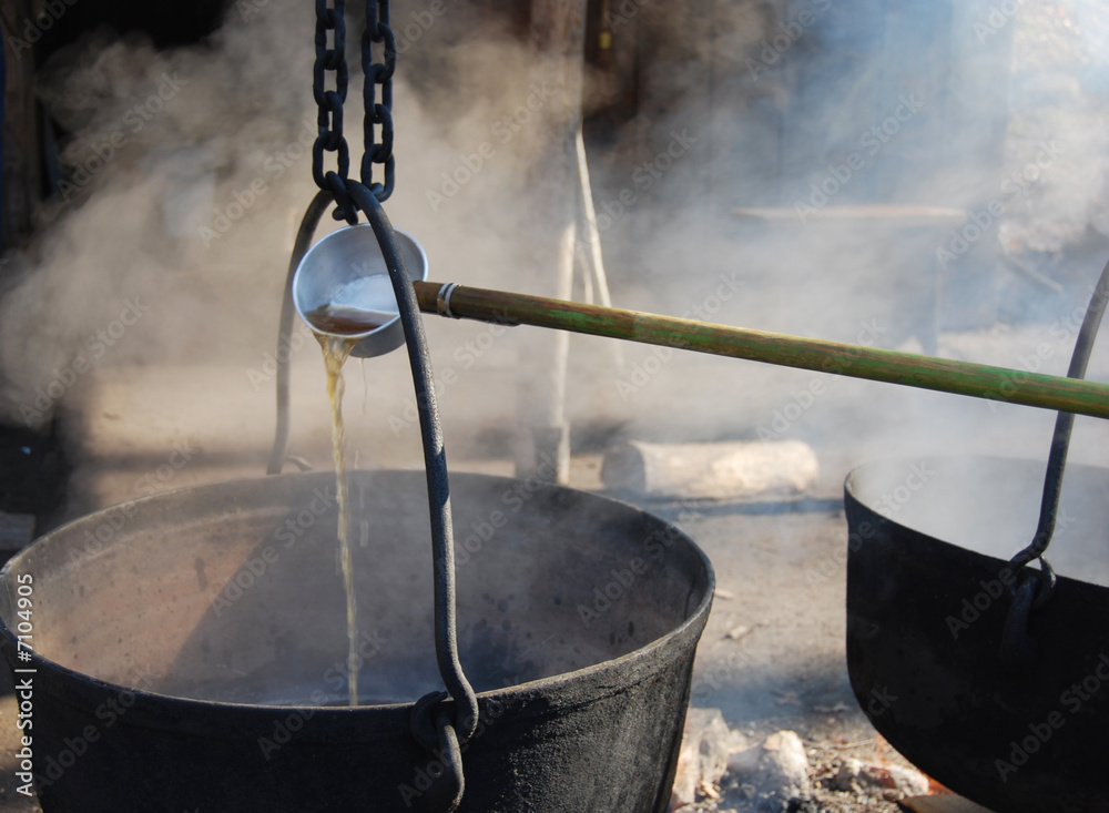 Wall mural making maple syrup by boiling the sap in a cauldron