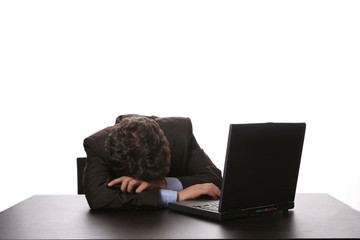 young business man sleeping on the laptop