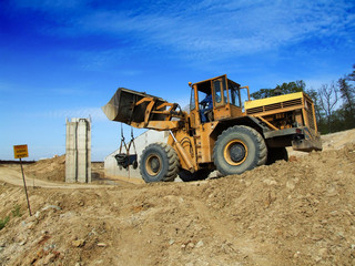 Front loader unloading concrete rubble