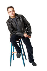 Fototapeta na wymiar Isolated Young Man with Glasses Sitting on a Stool