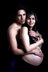 young expecting parents embracing