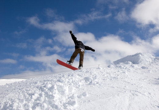 Snowboarder Landing After Jump