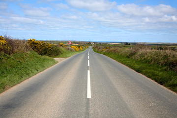 Fototapeta na wymiar An English country road with the sea on the horizon.