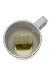 Teabag in an empty cup isolated on white background
