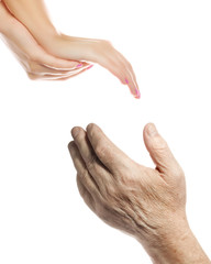 Hands of young woman and elderly man over white background