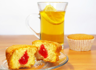 Cup of tea with the lemon abd cakes