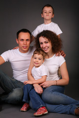 family in studio on dark background