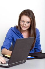 woman looking over computer