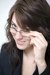 woman smiling and holding glasses
