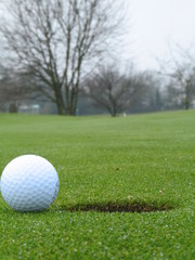 golf ball beside hole