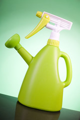Green plastic watering can