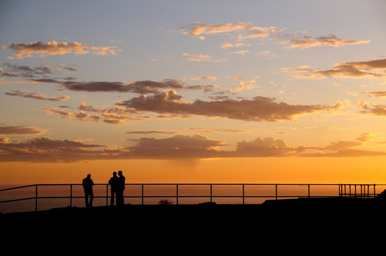 Men silhoutted against sunset