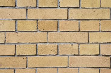 Wall with yellow bricks background/texture