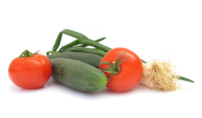 Cucumbers, tomatoes and scallion isolated on white background