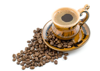 Coffee beans and black coffee in a cup