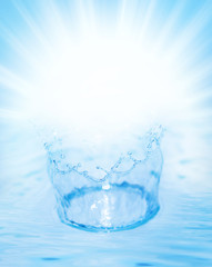 Splashing water over abstract blue background