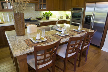 Luxury home kitchen with a granite island.