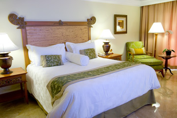 Interior of a hotel suite room showing a king sized bed
