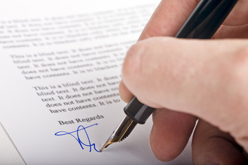 Signing letter with a pen