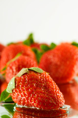 Strawberry falling in juice