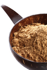 spice ground Ginger in coconut bowl isolated on white