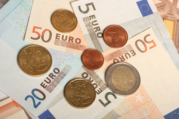 Euro notes and coins, close-up