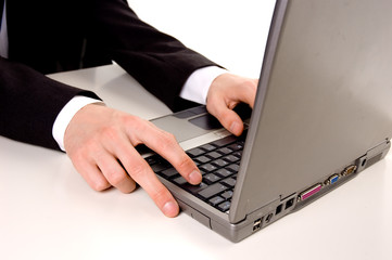 Businessman typing on laptop computer